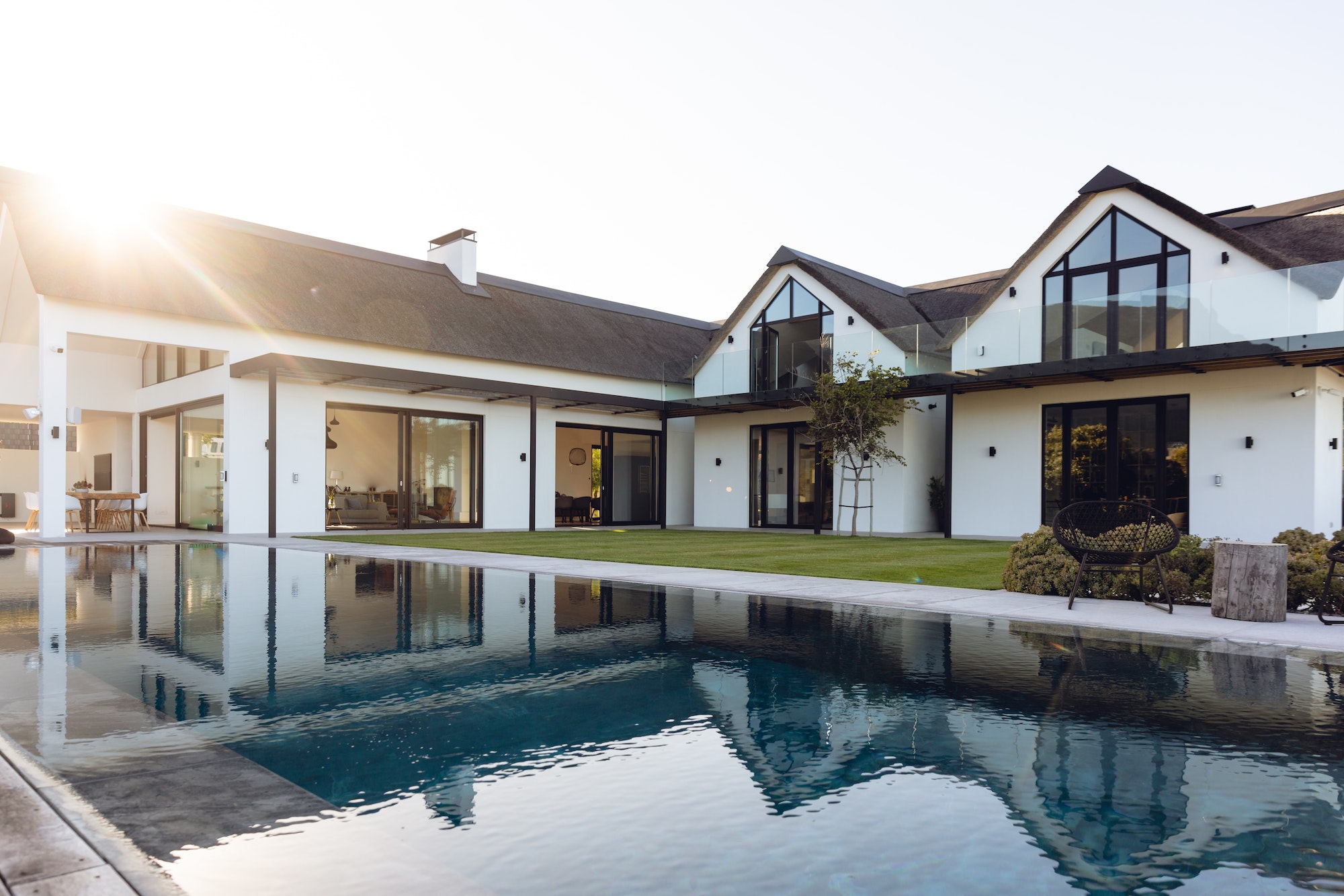 View of luxurious modern house exterior with garden and swimming pool
